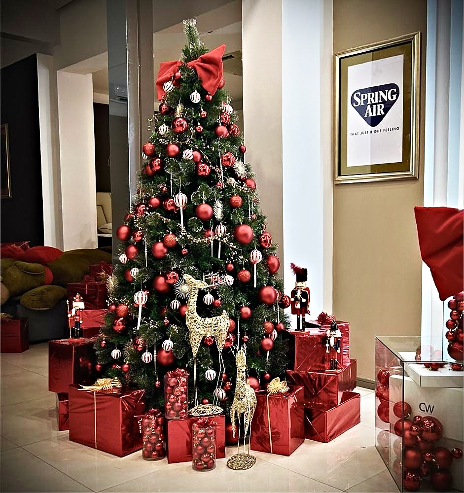 Gifts wrapped in bright paper under a tree