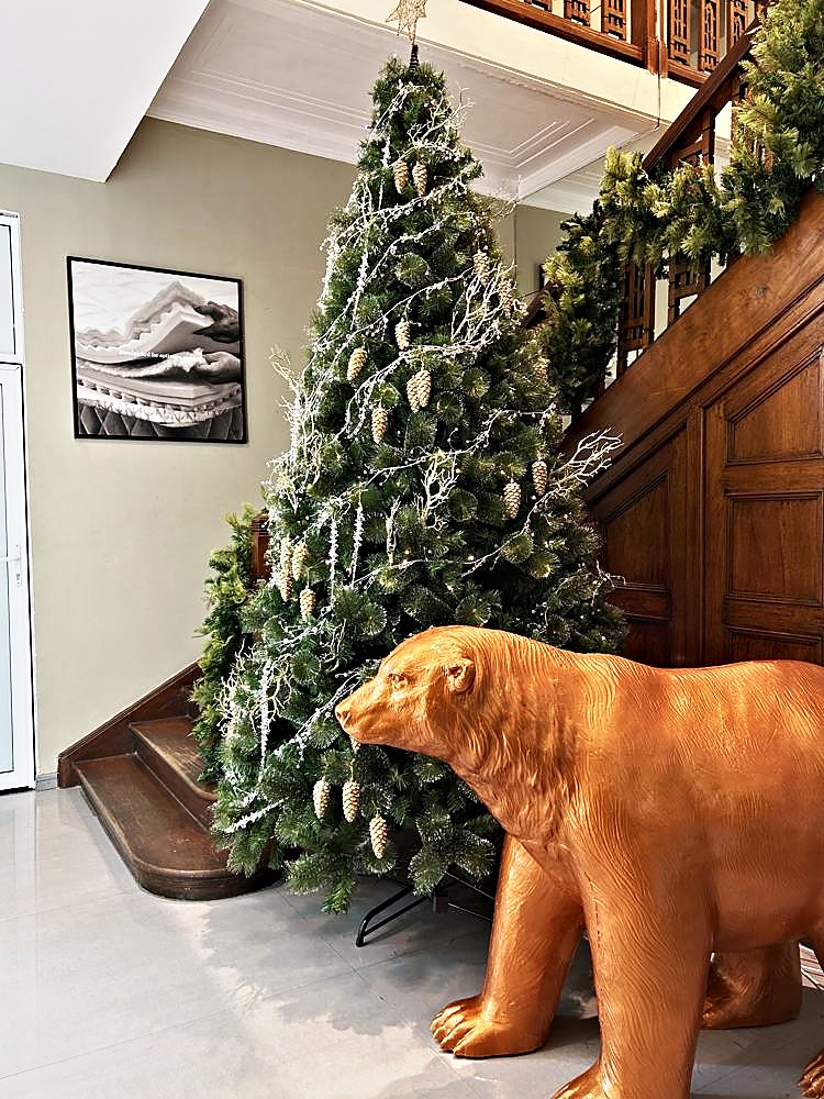 Tree with a copper bear at the foot of a staircase